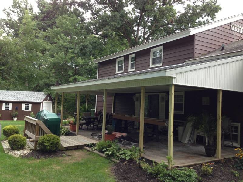 Photo of a medium sized farmhouse back terrace in Bridgeport with a roof extension.