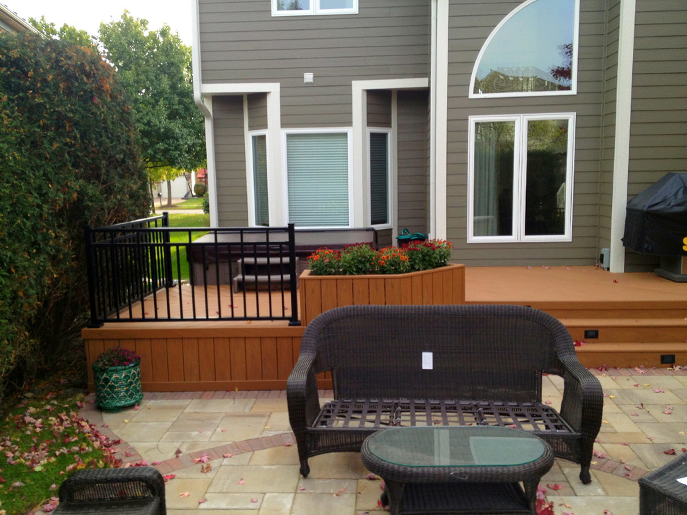 Deck - large traditional backyard deck idea in Chicago with a fire pit and no cover