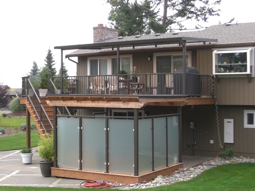 Deck - large traditional backyard deck idea in Seattle with an awning