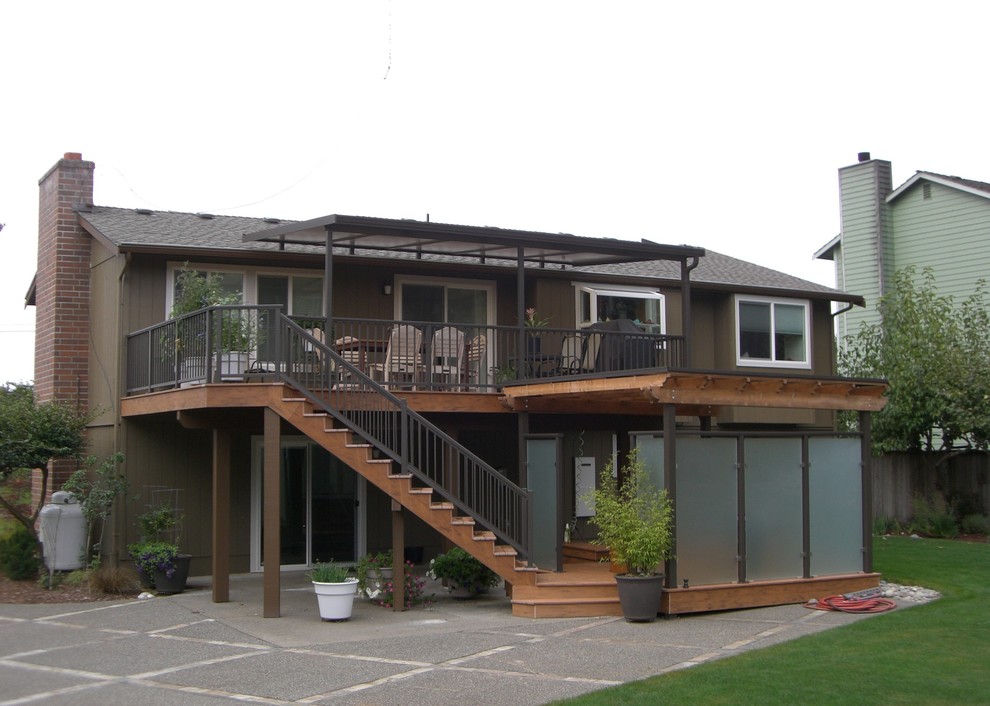 Inspiration for a large timeless backyard deck remodel in Seattle with an awning