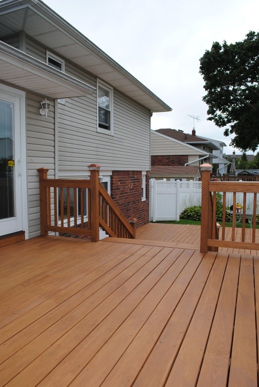 Example of a mid-sized classic backyard deck design in New York with no cover