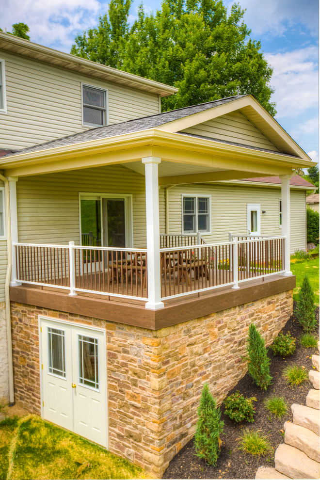 Deck with roof over and stone veneer Traditional Deck