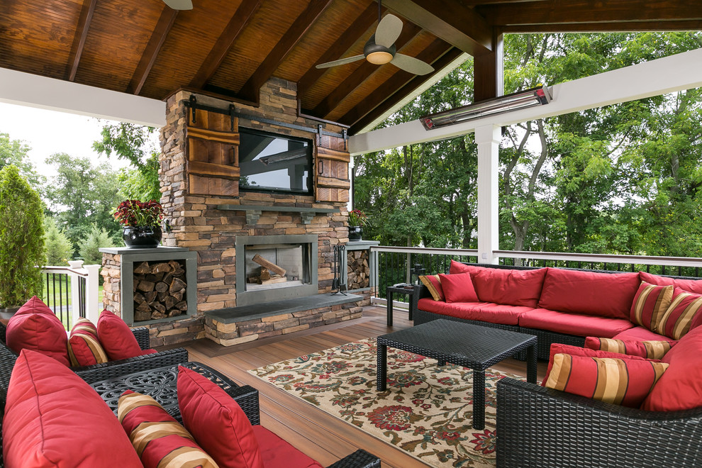 Example of a large classic backyard mixed material railing deck design in Baltimore with a roof extension