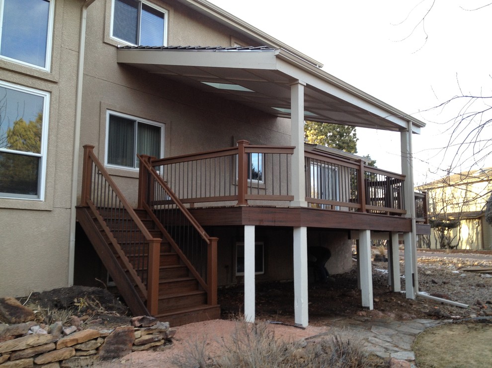 Mid-sized elegant backyard deck photo in Denver with a roof extension