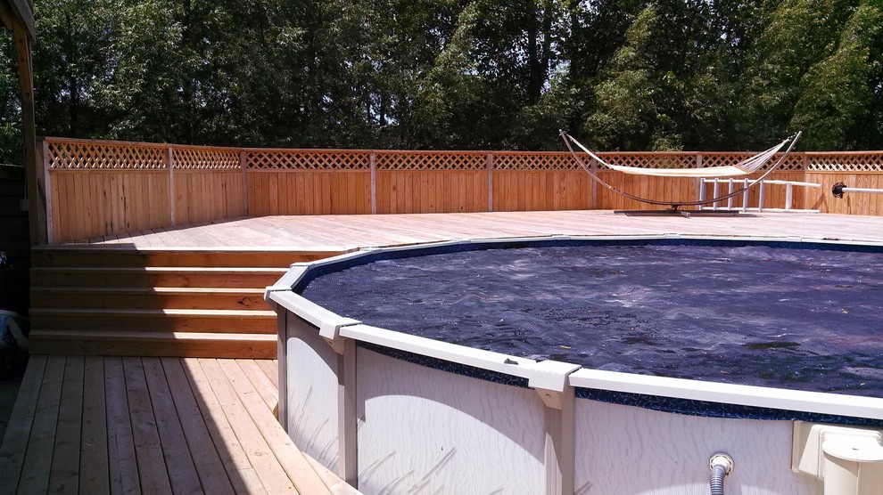 Example of a huge beach style backyard deck design in Milwaukee with no cover