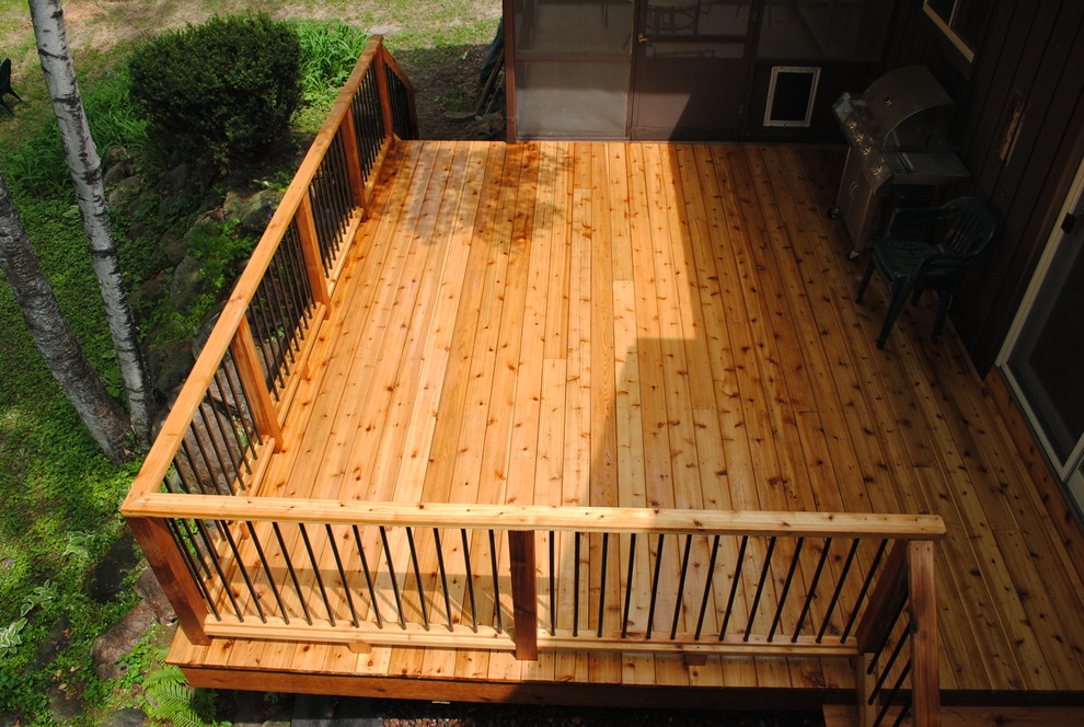 Deck - mid-sized craftsman side yard deck idea in Other with a roof extension