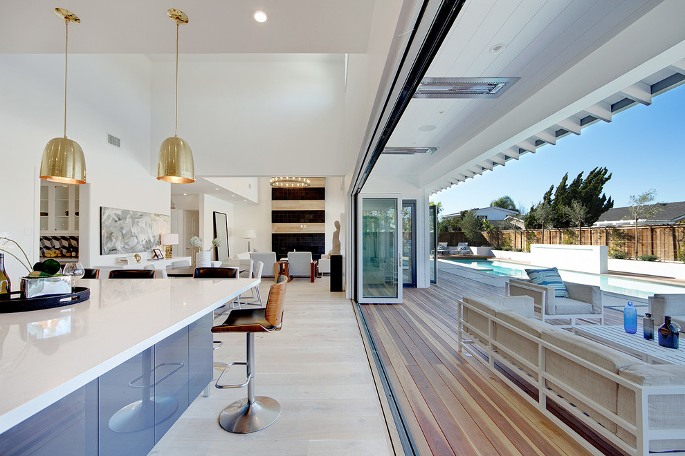 Photo of a large contemporary back terrace in Orange County with a roof extension.