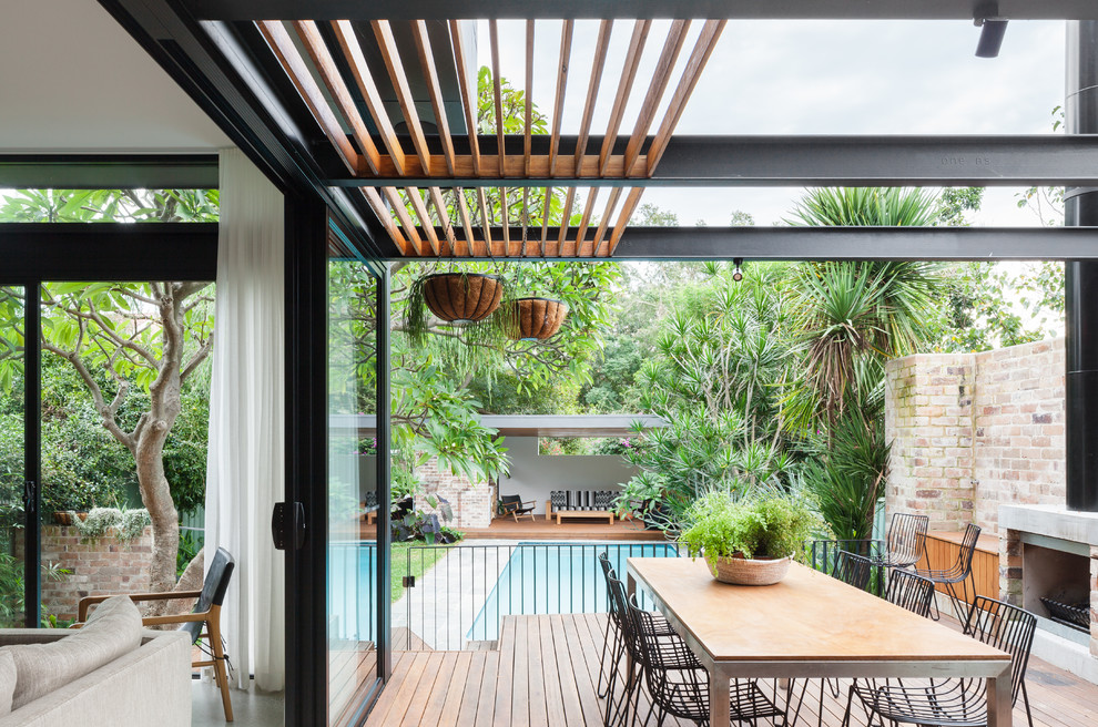 This is an example of a medium sized back terrace in Sydney with a pergola.