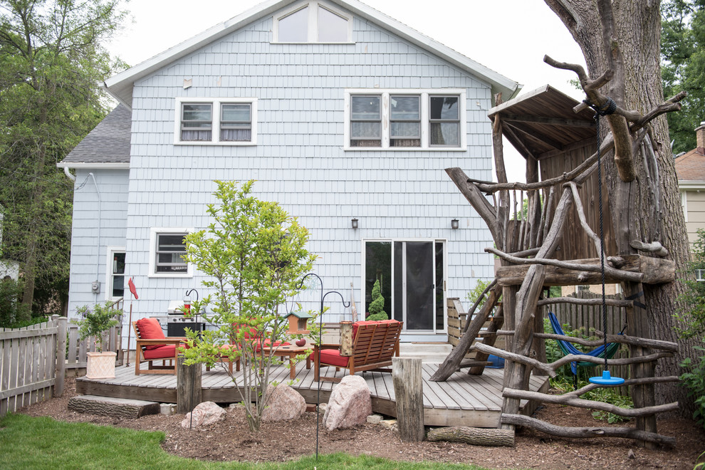 Example of a mid-sized eclectic backyard deck design in Milwaukee with no cover