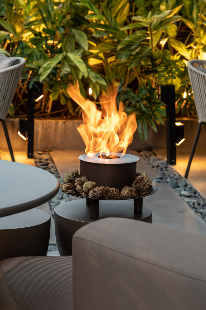 This is an example of an expansive world-inspired roof rooftop terrace in Miami with a fireplace.