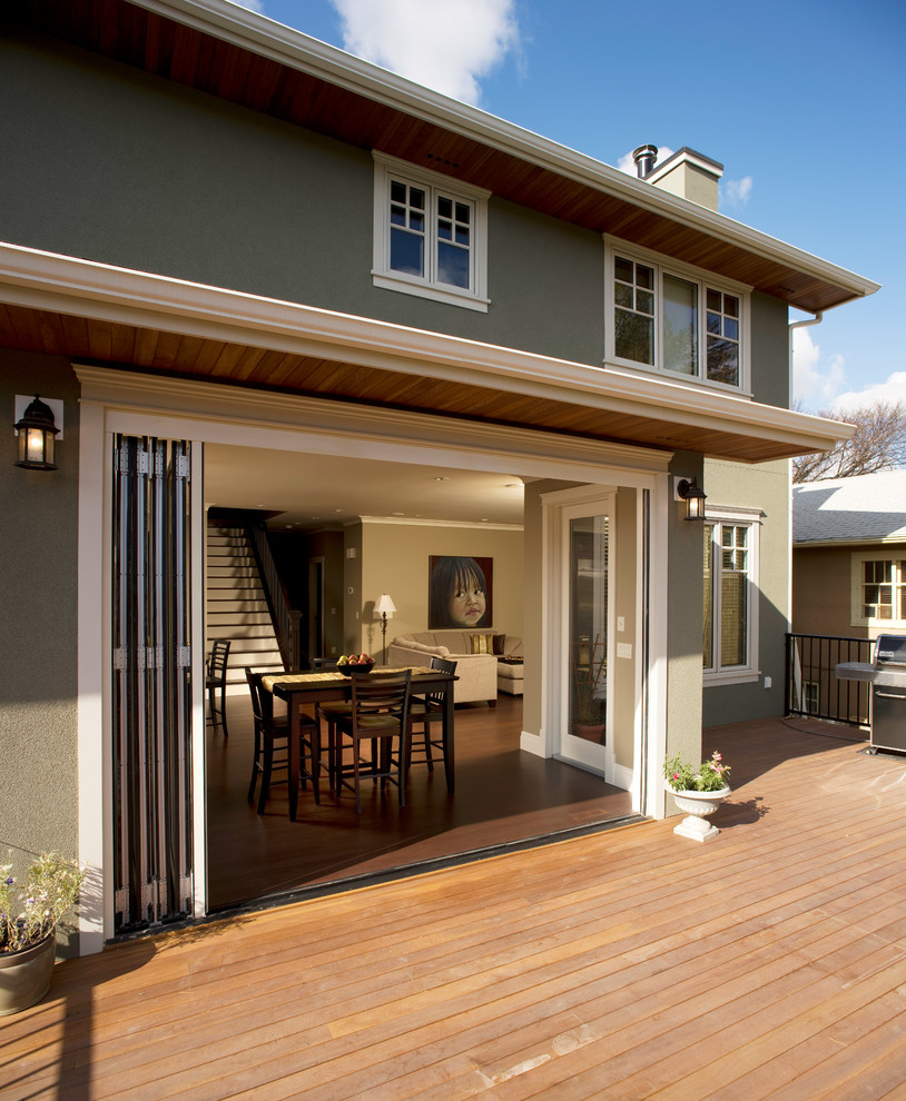 Inspiration for a large craftsman backyard deck remodel in Calgary with an awning