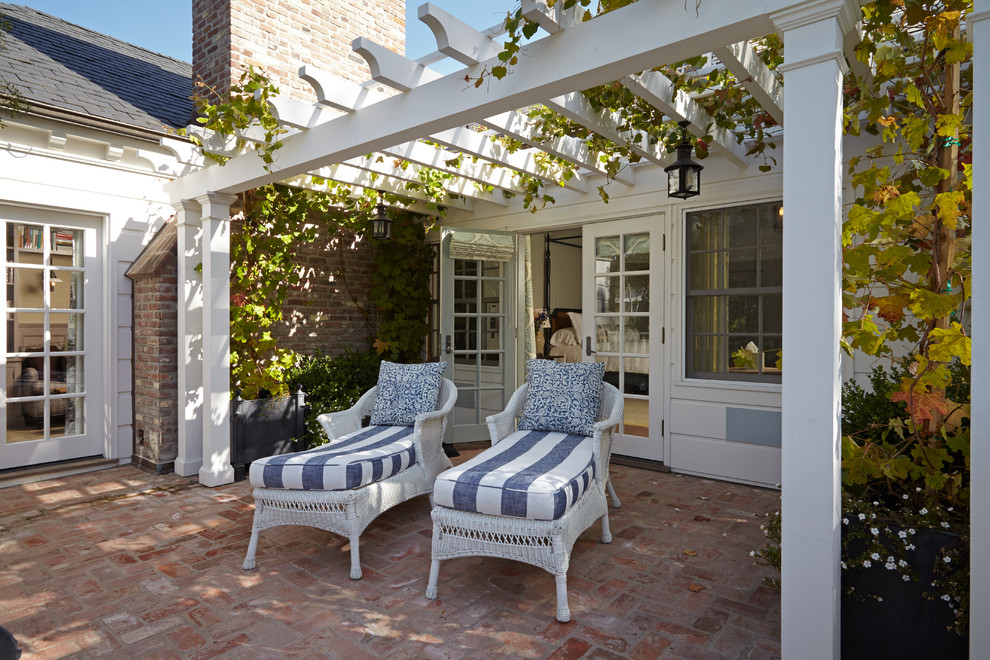 Patio - large traditional patio idea in Los Angeles with a pergola