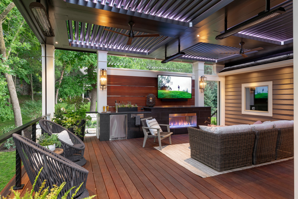 Inspiration for a mid-sized contemporary backyard privacy deck remodel in Minneapolis with a pergola
