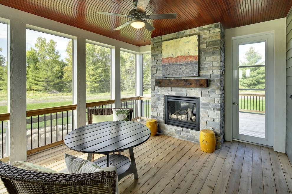 Photo of a large classic back terrace in Minneapolis with a fire feature and a roof extension.