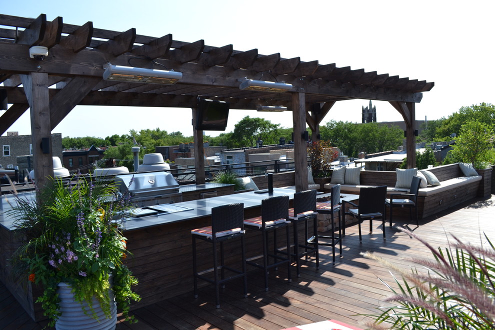 Inspiration for a huge contemporary rooftop deck remodel in Chicago with a fire pit and a pergola