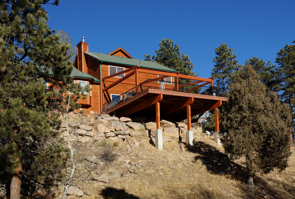 Large rustic terrace in Denver with an awning.