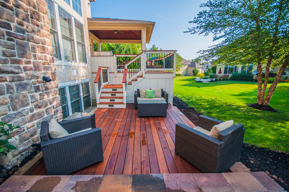 Deck - large transitional backyard deck idea in Columbus with a roof extension