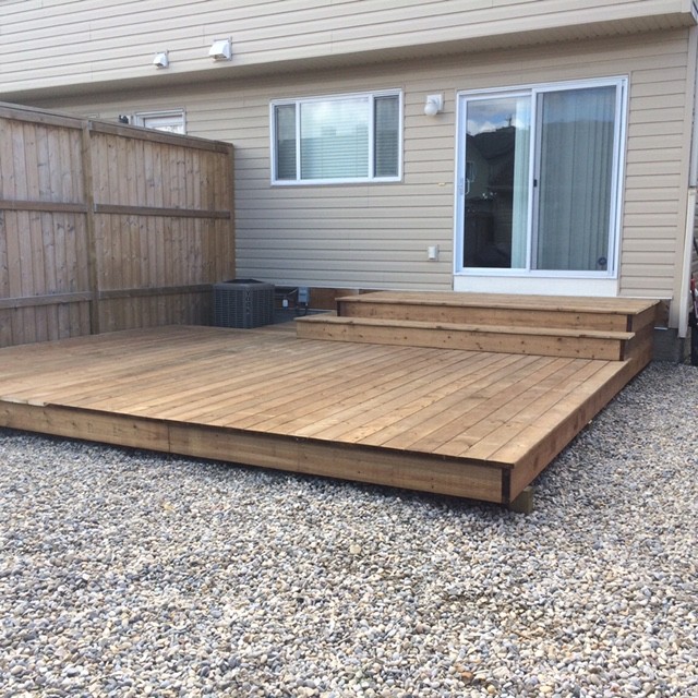 Inspiration for a mid-sized contemporary backyard deck remodel in Calgary with no cover