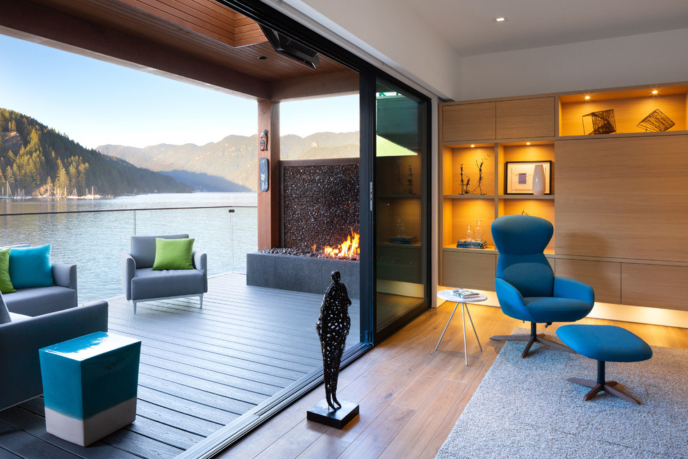 Design ideas for a large modern back terrace in Vancouver with a fireplace and a roof extension.