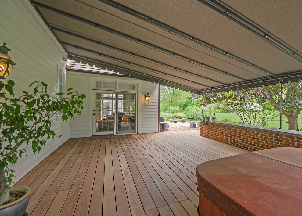 Photo of a large classic back terrace in Wilmington with an awning.