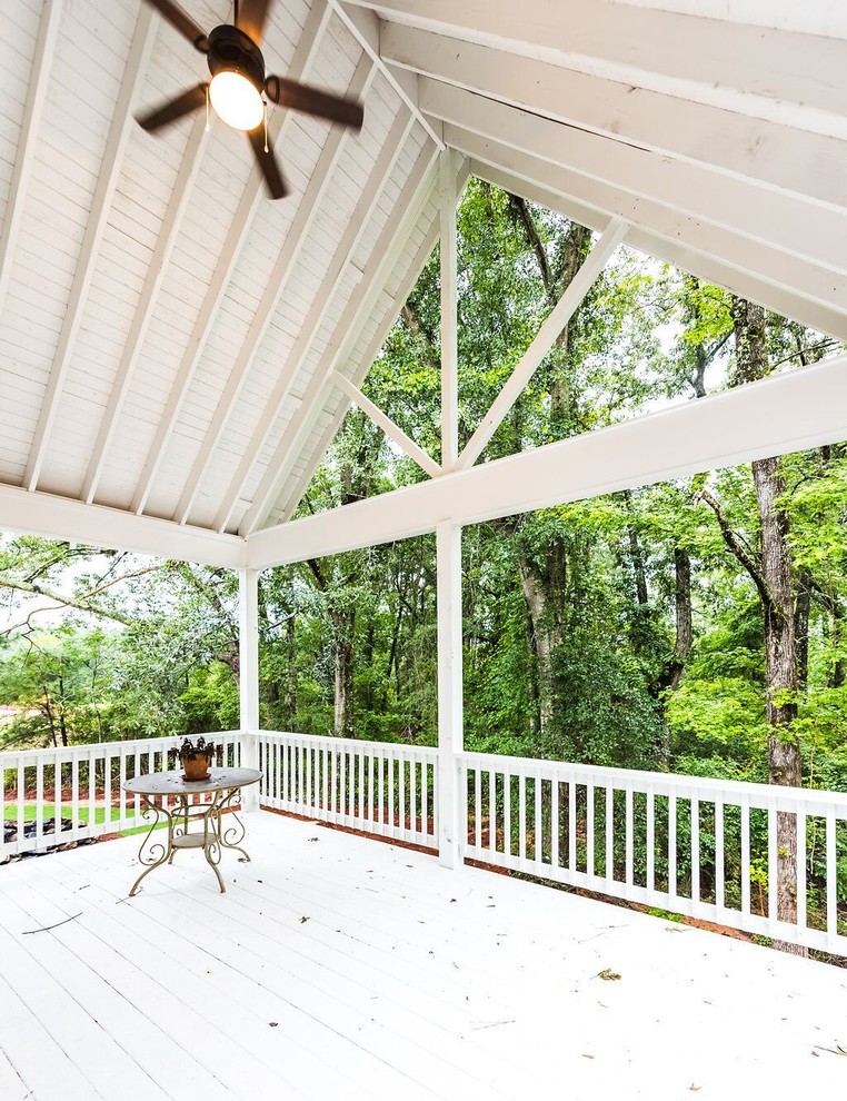 Large farmhouse backyard deck photo in Atlanta with a roof extension