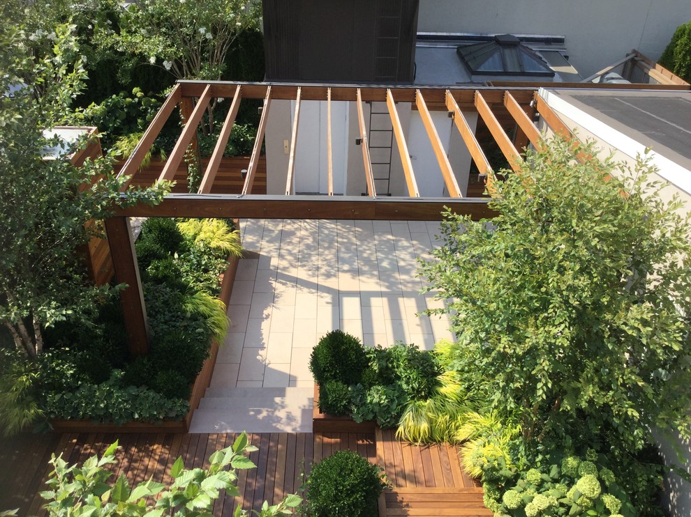 Example of a large minimalist deck container garden design in New York with a pergola