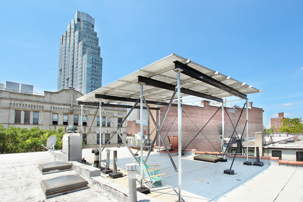 This is an example of a medium sized urban roof terrace in New York with a pergola.