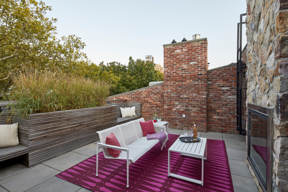 Example of a mid-sized trendy rooftop deck design in New York with a fireplace and no cover