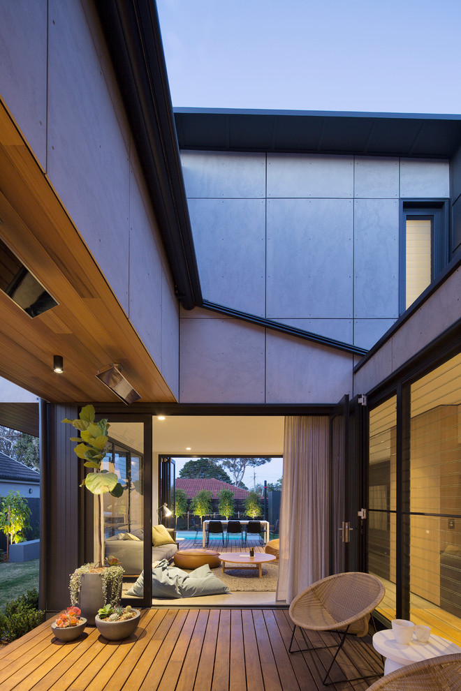 Foto de terraza contemporánea de tamaño medio en patio lateral con toldo