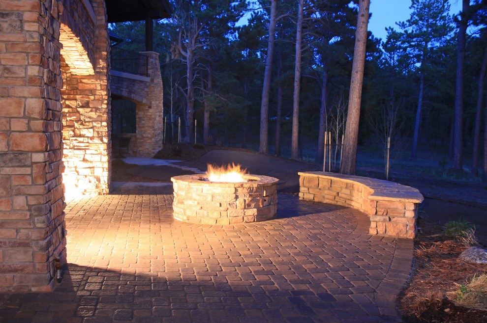 Example of a large classic backyard deck design in Denver with a fire pit and no cover