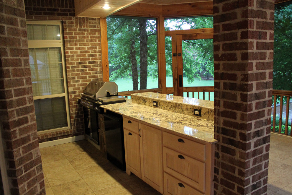 Photo of a large traditional back terrace in Little Rock with an outdoor kitchen and a roof extension.