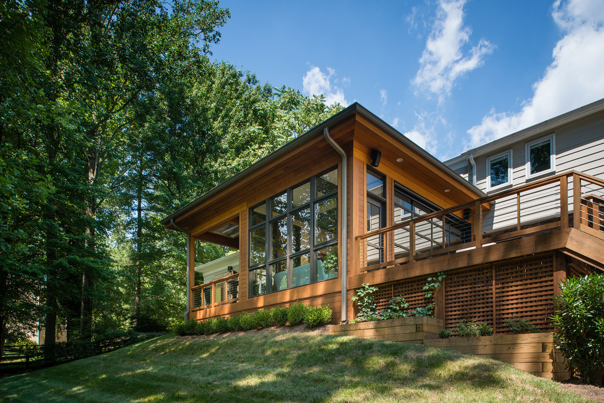 Inspiration for a mid-sized transitional backyard deck remodel in DC Metro with a fire pit and a roof extension