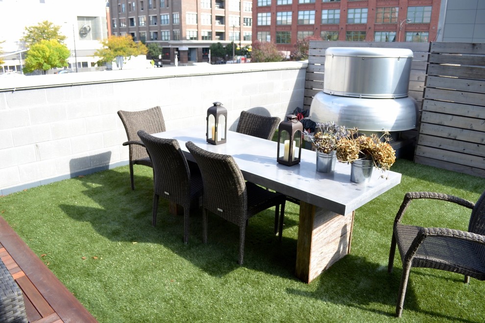 This is an example of a medium sized contemporary roof terrace in Chicago with a fire feature and a pergola.