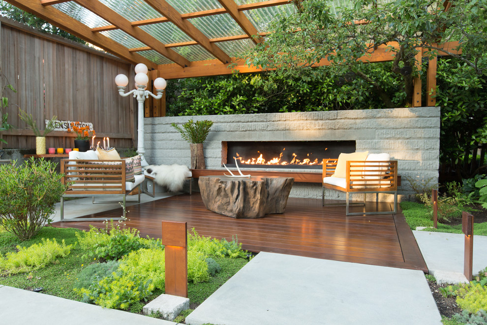 Inspiration for a mid-sized contemporary backyard deck remodel in Seattle with a fireplace