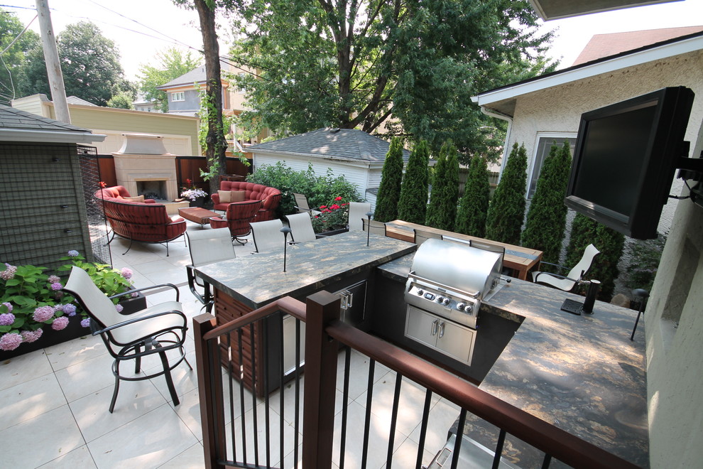 Inspiration for a large contemporary back terrace in Chicago with an outdoor kitchen and a pergola.