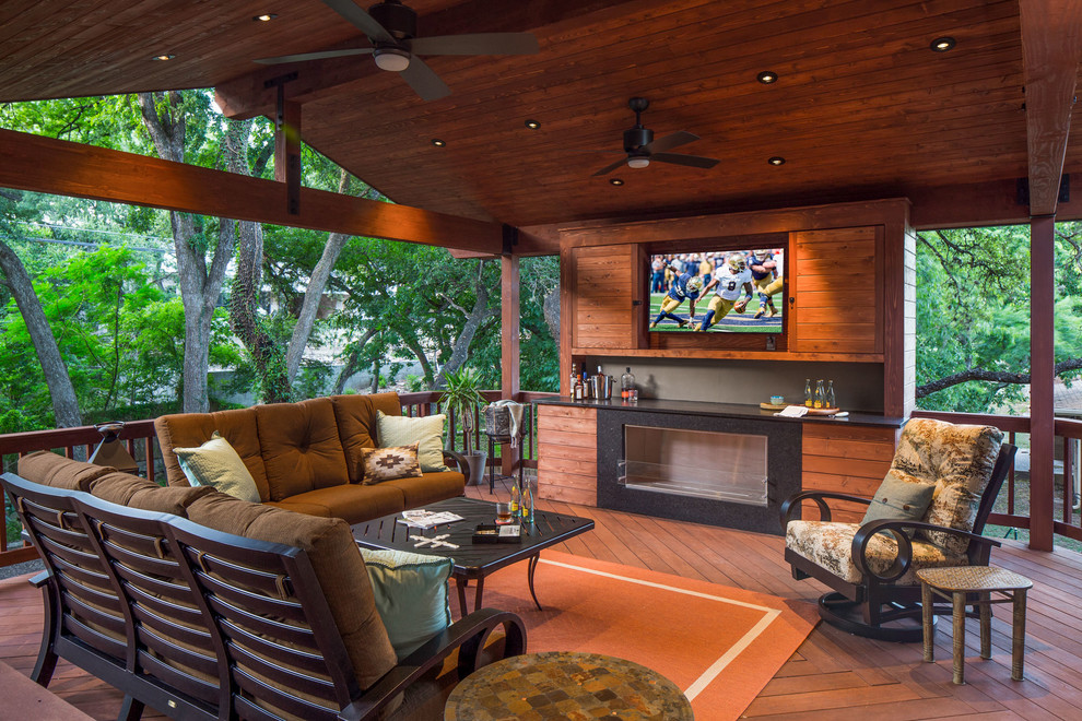 Mid-sized trendy backyard deck photo in Austin with a fire pit and a roof extension