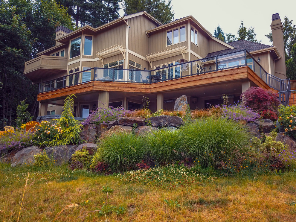 This is an example of a large classic back terrace in Seattle with a fire feature and no cover.