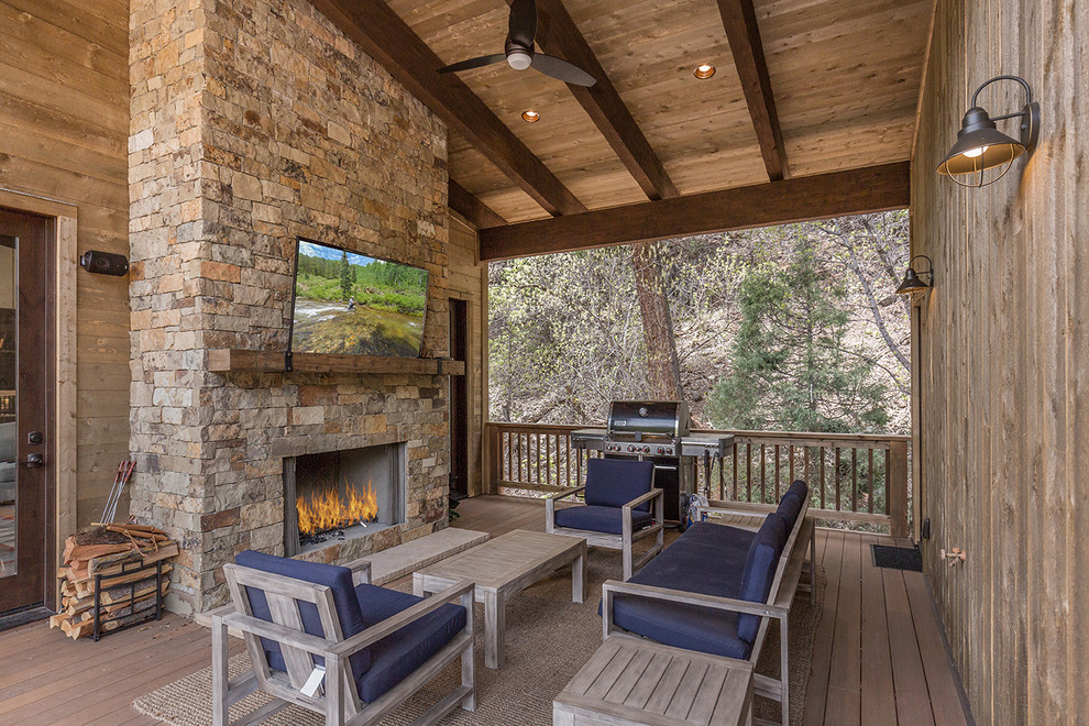 Rustic terrace in Albuquerque with a fireplace, feature lighting and a roof extension.
