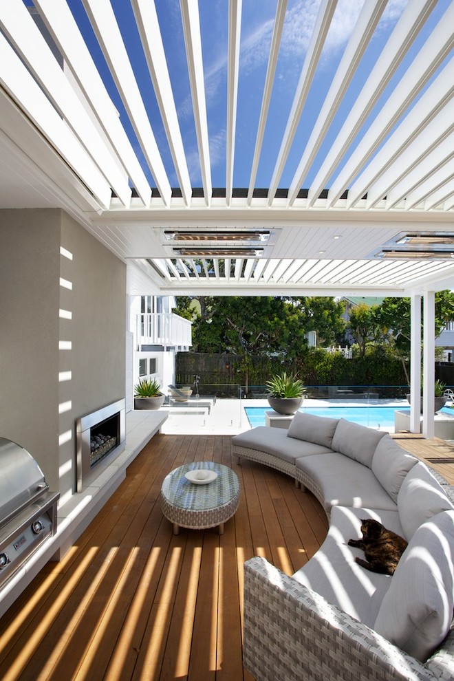 Classic back terrace in Auckland with an outdoor kitchen and a pergola.