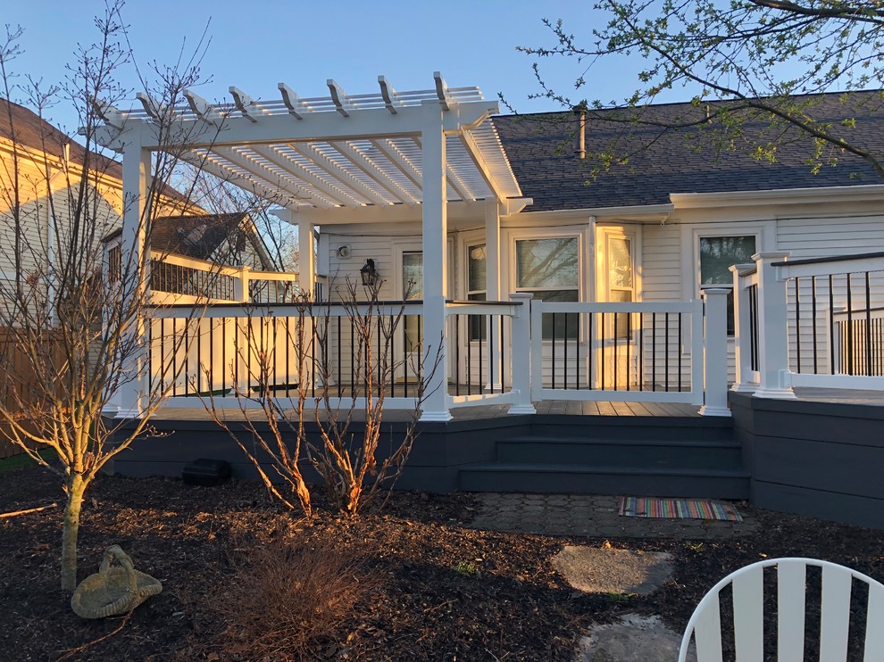 Example of a large eclectic backyard deck design in Columbus with a pergola