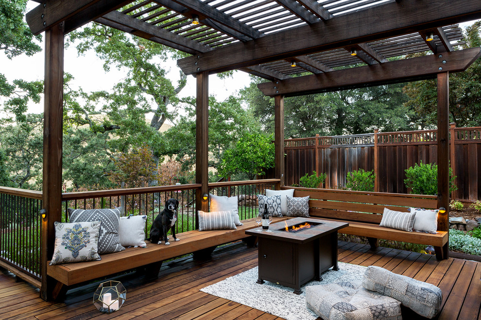 Example of a large classic backyard mixed material railing deck design in San Francisco with a fire pit and a pergola