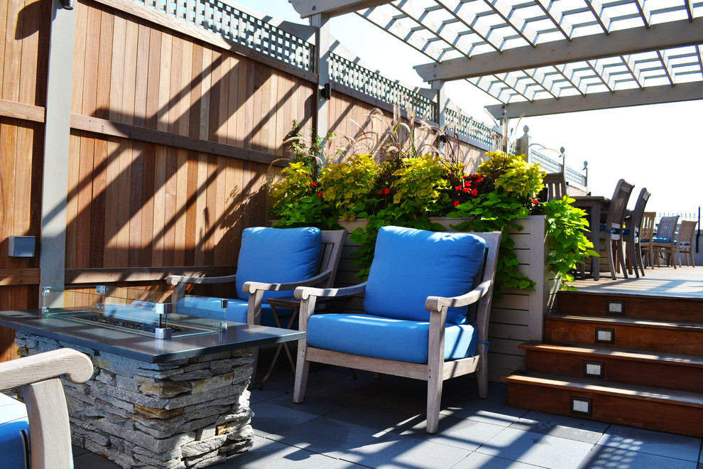 Large elegant rooftop deck photo in Chicago with a fire pit and a pergola