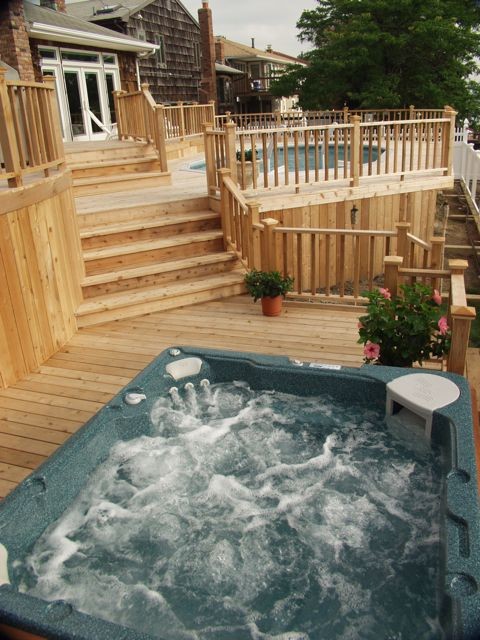 Example of a large mountain style backyard deck design with no cover