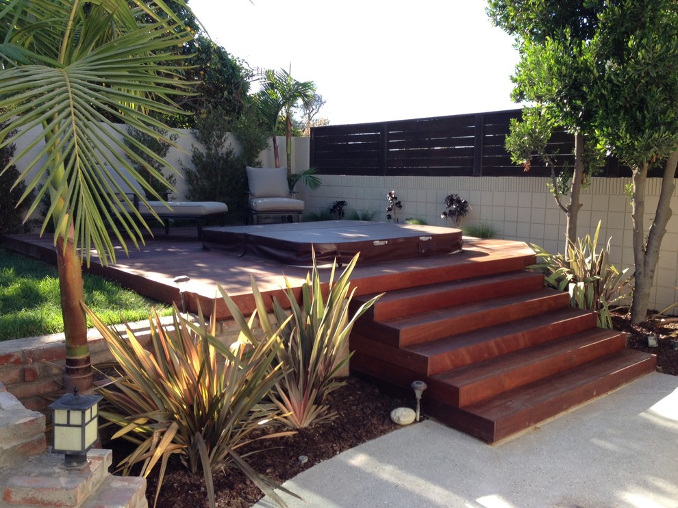 Medium sized classic back terrace in Los Angeles with a water feature and no cover.