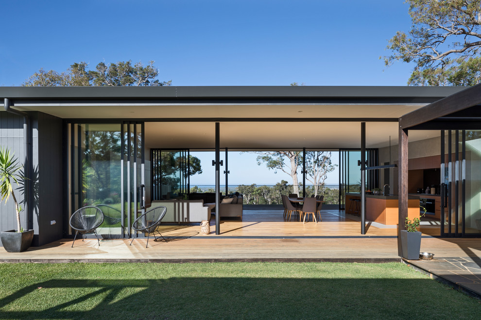 Inspiration for a large modern side yard deck remodel in Perth with a roof extension