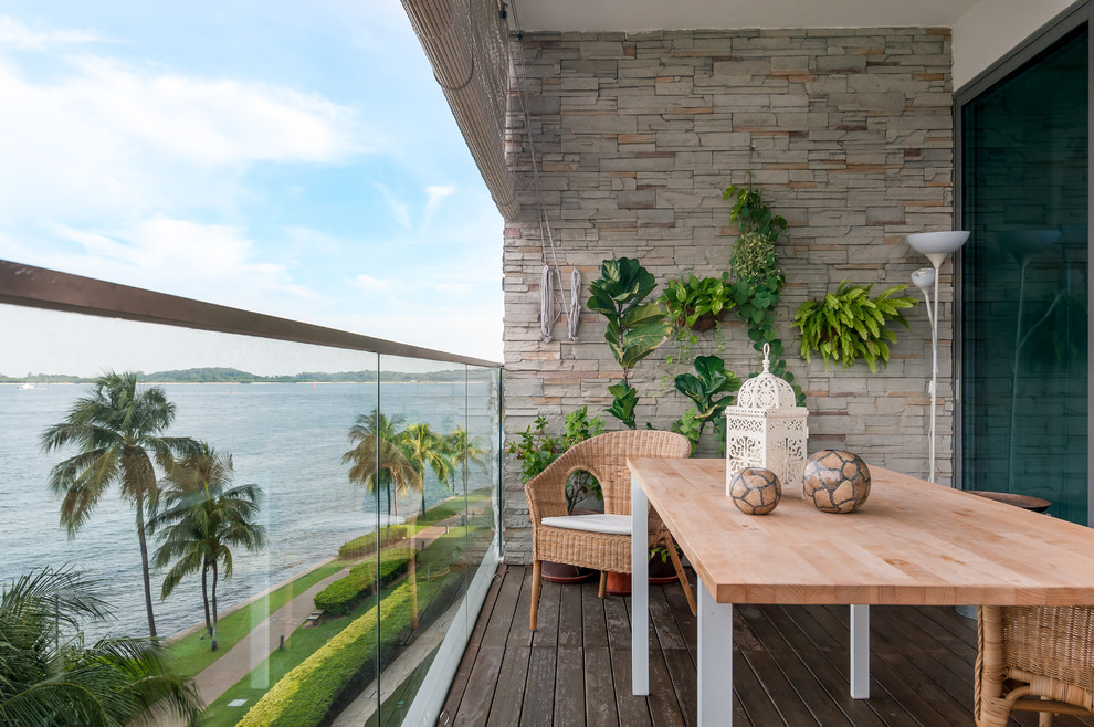 Inspiration for a tropical deck remodel in Singapore with a roof extension