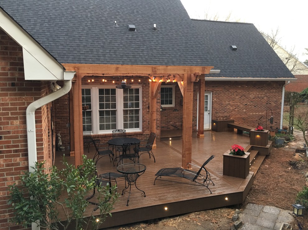 Inspiration for a large timeless backyard deck remodel in Other with a pergola