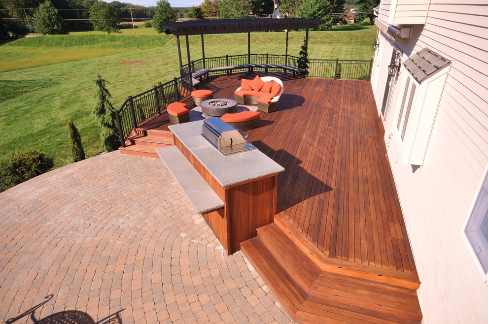 Deck - large transitional backyard deck idea in New York with a fire pit and a pergola