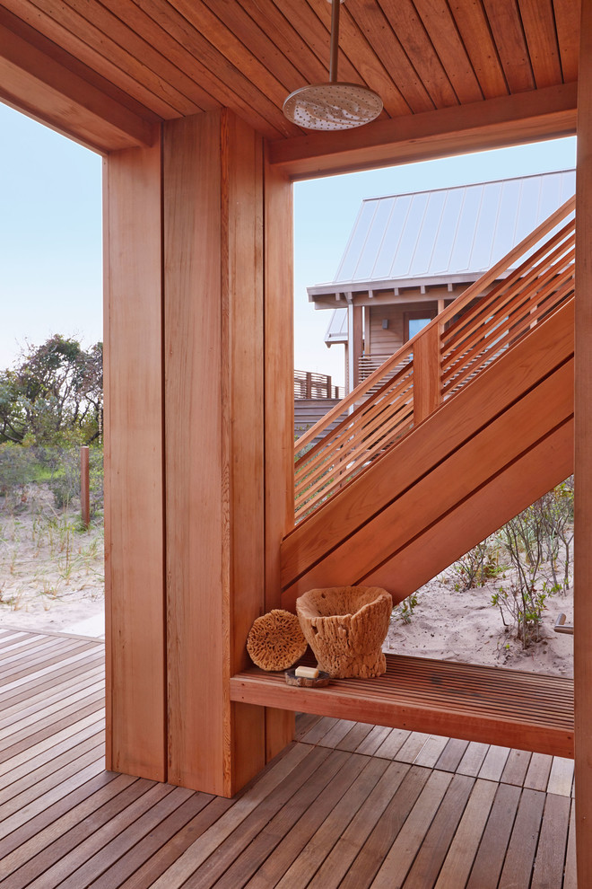 Inspiration for a large coastal backyard outdoor shower deck remodel in New York with a roof extension