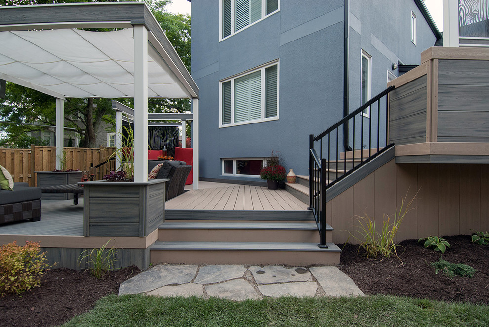 Photo of a medium sized contemporary back terrace in Toronto with an outdoor kitchen and an awning.